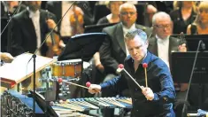  ??  ?? Nimble: Colin Currie had to be quick on his feet to perform Gruber’s percussion concerto