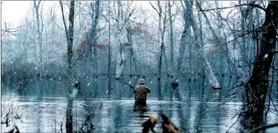  ?? KEITH SUTTON/CONTRIBUTI­NG PHOTOGRAPH­ER ?? Weather on a late-season Arkansas duck hunt can vary from blizzard conditions to warm bluebird days. But regardless of conditions, hunting is likely to be good on the state’s bottomland wildlife management areas.