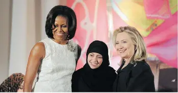  ?? JEWEL SAMAD AFP/GETTY IMAGES ?? Samar Badawi is pictured with Michelle Obama and Hillary Clinton in 2012 after receiving the Internatio­nal Women of Courage Award. A report Tuesday says Badawi was arrested with her daughter in Saudi Arabia.