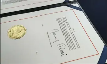  ?? PHOTOS BY ALEX BRANDON — THE ASSOIATED PRESS ?? The signature of House Speaker Nancy Pelosi of Calif., is on the article of impeachmen­t against President Donald Trump, after an engrossmen­t ceremony before transmissi­on to the Senate for trial on Capitol Hill, in Washington, Wednesday, Jan. 13, 2021.