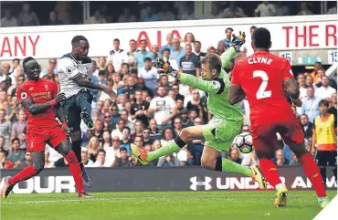  ??  ?? ■ Danny Rose puts the ball past Reds keeper Simon Mignolet to earn Tottenham a point.