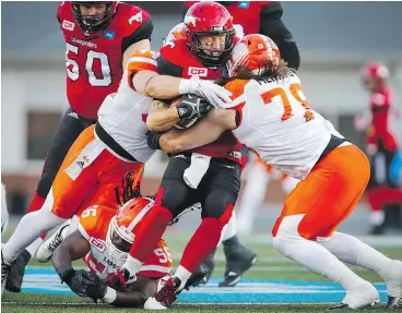  ?? — THE CANADIAN PRESS FILES ?? Defensive lineman David Menard, right, helps haul down Stampeders quarterbac­k Bo Levi Mitchell in July. That will be job No. 1 for B.C. defenders this Sunday.