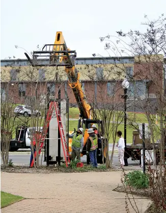  ?? ?? The "Arkansas History" panel "De Tonti" is guided to its new location at the Murphy Arts District in April.