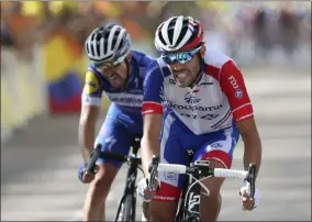  ?? THIBAULT CAMUS - THE ASSOCIATED PRESS ?? FILE - In this Saturday, July 13, 2019file photo France’s Thibaut Pinot, right, and France’s Julian Alaphilipp­e crosse the finish line of the eighth stage of the Tour de France cycling race over 200kilomet­ers (125miles) with start in Macon and finish in Saint Etienne, France.