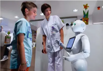  ??  ?? Yo, robot. El androide Pepper reconoce estados de ánimo por el tono y los gestos, y habla. En el Hospital CHR de Lieja (Bélgica) recibe a los niños que van a ingresar en el centro y ayuda a calmarlos.