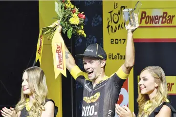  ??  ?? Stage winner Slovenia’s Primoz Roglic celebrates on the podium after winning the 183 km seventeent­h stage of the 104th edition of the Tour de France cycling race on July 19, 2017 between Le La Mure and Serre-Chevalier, French Alps.