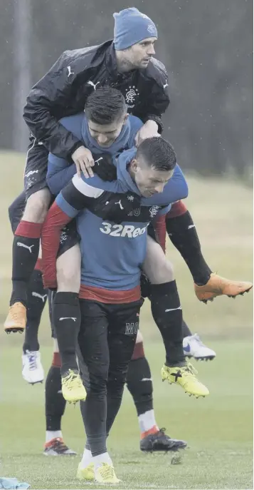  ??  ?? Rangers players Jamie Murphy, top, Declan John, middle, and Michael O’halloran seem to be enjoying training yesterday ahead of tomorrow’s Old Firm Scottish Cup semi-final at Hampden.