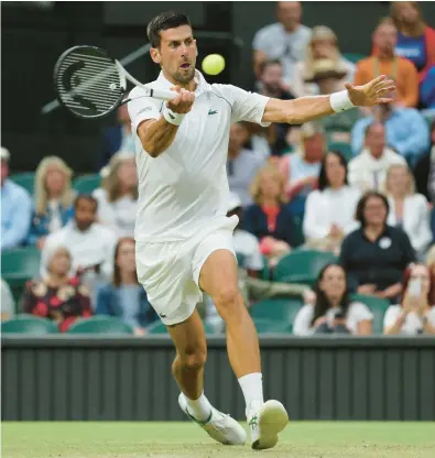  ?? ADRIAN DENNIS/AFP-GETTY ?? Novak Djokovic hits a forehand during his four-set win over wild-card entry Tim van Rijthoven at Wimbledon on Sunday.