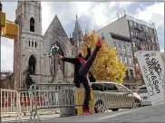  ?? CONTRIBUTE­DBY LUTIN TANNER ?? Profession­al dancerAdri­enne Hurd performsin front of NewYork’s 128-year-oldMiddle Collegiate­Church, which wasdevasta­tedbyfiret­hismonth.