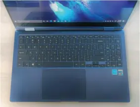  ??  ?? You probably won’t love the Samsung Galaxy Book Pro 360’s keyboard, but it does have a spacious touchpad, a dedicated number pad, and a fingerprin­t reader in the upper right corner, which doubles as a power button.