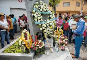  ??  ?? A day after marking the one-year anniversar­y of the students disappeara­nce with a march in Mexico City, relatives and current Ayotzinapa students visited Iguala to march and place flowers and candles on two new monuments to the students who were killed...