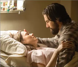  ?? Associated Press photo ?? This image released by NBC shows Mandy Moore, left, and Milo Ventimigli­a in a scene from “This Is Us.” The season finale for the popular time-twisting family drama will air Tuesday at 9 p.m. EST on NBC.