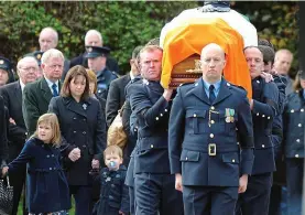  ??  ?? Funeral: Tony Golden’s wife Nicola and children behind his coffin