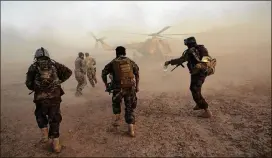  ?? MASSOUD HOSSAINI / AP ?? Afghan army commandos train Sunday at the Shorab military camp in Helmand province, Afghanista­n. A senior Afghan security official said the Taliban wanted certain amendments to the constituti­on — although not immediatel­y.