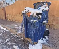  ?? AMANDA MARTINEZ/THE NEW MEXICAN ?? A burned recycling bin sits Wednesday morning outside a residence near the intersecti­on of West Buena Vista and Granada streets in the South Capitol neighborho­od. Four trash and recycling bins have been lit on fire in the downtown area this week.