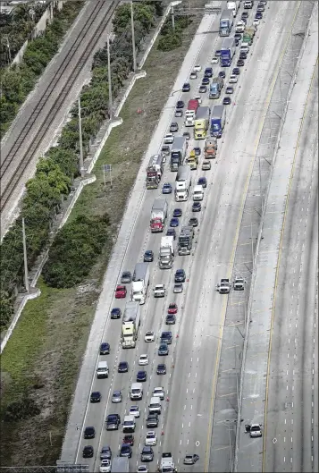  ?? BRUCE R. BENNETT / THE PALM BEACH POST ?? Southbound traffic on Interstate 95 near Lantana can be seen backing up Wednesday after a series of crashes and a deputy-involved shooting in the northbound lanes.