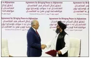  ?? HUSSEIN SAYED — THE ASSOCIATED PRESS FILE ?? U.S. peace envoy Zalmay Khalilzad, left, and Mullah Abdul Ghani Baradar, the Taliban group’s top political leader shake hands in February 2020after signing a peace agreement between Taliban and U.S. officials in Doha, Qatar.