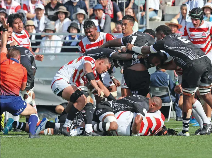  ?? Photo: Kenji Demuri ?? Fiji Airways Flying Fijians hooker Sam Matavesi (buried among the players) scores one of their two tries against Japan at the Kamaishi Recovery Memorial Stadium at the Iwate Prefecture on July 27,2019.