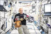  ?? COURTESY OF NASA ?? Astronaut Jeff Williams monitors bowling ball-sized internal satellites during a maintenanc­e run in the Internatio­nal Space Station.