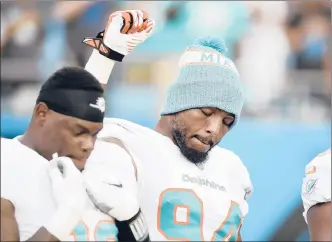  ?? MIKE MCCARN | AP ?? MIAMI’S ROBERT QUINN, shown here during Week 2 of the preseason at Carolina,was one of a number of players to raise a fist during the playing of the anthem duringthe preseason.