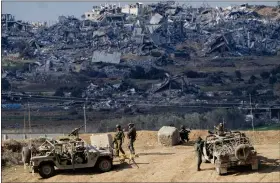  ?? AP PHOTO/ARIEL SCHALIT ?? Israeli soldiers take up positions near the Gaza Strip border, in southern Israel, Friday, Dec. 29, 2023.