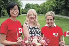  ?? JESSICA NYZNIK/EXAMINER ?? Yvonne Lai, New Canadians Centre (NCC) community developmen­t director, left, Dayle Finland, of Divine Cupcakes by Dayle, and Carol Lawless, NCC fund developmen­t co-ordinator, get into the Canada Day spirit during a press conference at Millennium Park...