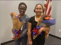  ?? SUBMITTED PHOTO ?? Eileen Badoo, left, and Savannah Moulton, right, both fourth graders at Eddystone Elementary School, were the winners of the annual Women’s History Month essay contest sponsored by Eddystone Borough Council. The topic was “The Person I Most Admire.” Both girls selected their mothers as the person they most admire. The winners received bouquets of flowers and gift cards at this month’s Eddystone Borough Council meeting.