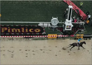  ?? — GETTY IMAGES ?? American Pharoah, ridden by Victor Espinoza, crosses the finish line to easily win the Preakness Stakes on Saturday in Baltimore.