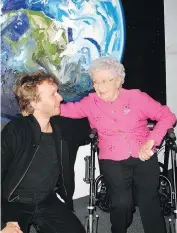  ??  ?? Artist Erik Olson and his proud grandmothe­r Ethel Gibbs attended Glenbow’s VIP opening reception together. Olson’s portraits of planets are part of the exhibit Cosmos, which runs at the museum through Jan 6. They posed in front of one of his planetary pieces.