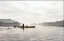  ??  ?? A lone kayaker glides through the Haida homeland.