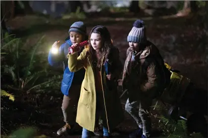  ?? APPLE TV PLUS ?? From left, Jibrail Nantambu, Brooklynn Prince and Deric McCabe investigat­e a murder in a scene from “Home Before Dark.”