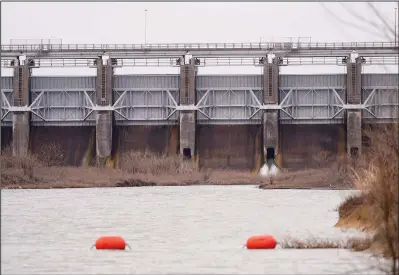  ?? (File Photo/AP/LM Otero) ?? Water flows Feb. 16 out of the Rockwall-Forney Dam in Forney, Texas.