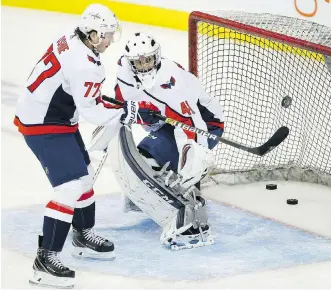  ?? JOHN WOODS / THE CANADIAN PRESS ?? Goalie Gavin McHale warms up alongside T.J. Oshie as the Caps prepared to face the Jets on Wednesday. McHale was an emergency call-up.