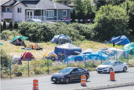  ?? DARREN STONE, TIMES COLONIST ?? Firefighte­rs are concerned about the Regina Park encampment across from Uptown shopping centre.