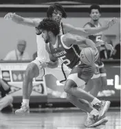  ?? MATT GENTRY AP ?? Miami's Norchad Omier drives against Virginia Tech’s Mylyjael Poteat on Tuesday night at Blacksburg, Virginia.