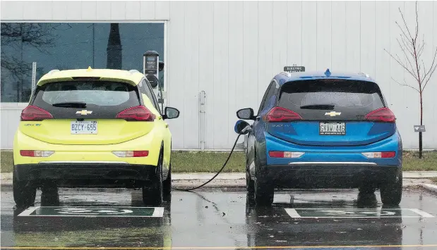  ?? LARS HAGBERG / AFP / GETTY IMAGES ?? Two electric vehicles were getting charged at the GM plant in Oshawa on Monday as the company was announcing the plant’s imminent closing.