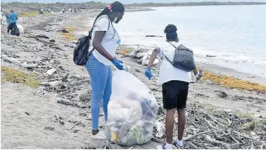  ?? CONTRIBUTE­D PHOTOS ?? Members of the Kiwanis and Circle K clubs remove plastic and other waste from the Fort Rocky Beach. The Kiwanis Club of North St Andrew has committed to continue its work in sponsoring the youth of Circle K to care for the environmen­t.