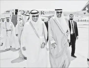  ?? Kuwait News Agency ?? QATARI Foreign Minister Sheik Mohammed bin Abdulrahma­n al Thani, left, is met in Kuwait by counterpar­t Sheik Sabah al Khaled al Sabah. Kuwait is trying to mediate an end to Qatar’s blockade by four neighbors.