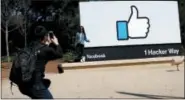  ?? MARCIO JOSE SANCHEZ - THE ASSOCIATED PRESS ?? In this March 28, 2018, file photo, visitors take photos in front of the Facebook logo at the company’s headquarte­rs in Menlo Park, Calif. Facebook reported earnings Wednesday, April 25.