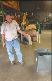  ?? SHAKA L. COBB / Staff ?? John Anderson shows off some materials they use in homes to help customers keep it energy efficient.