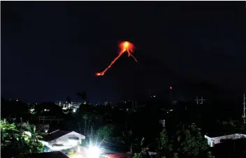  ?? AP FOTO ?? ERUPTION. Lava cascades down the slopes of Mayon volcano as seen from Legazpi City, Albay. More than 9,000 people have evacuated from the area around the volcano.