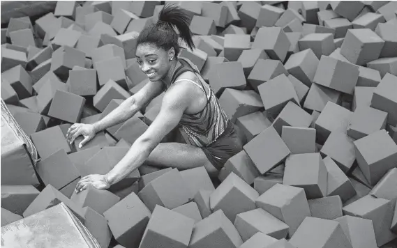  ?? Marie D. De Jesús / Staff photograph­er ?? After a year of trials and success, Simone Biles is taking time off. She spent part of a recent workout in the foam pit (relaxing?) at World Champions Centre in Spring.