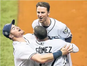  ?? CHRIS URSO/TAMPA BAY TIMES/TNS ?? Tampa Bay Rays third baseman Matt Duffy, top, with Carlos Gomez and Christian Arroyo, didn’t have the World Series-winning hit, just one that gave Tampa Bay a third straight win over Toronto.