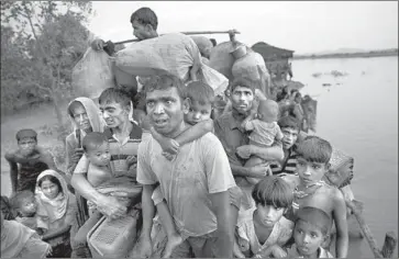  ?? Bernat Armangue Associated Press ?? ROHINGYA refugees cross into Bangladesh. About 700,000 Rohingyas have fled to Bangladesh as Myanmar’s government unleashed what the U.N. and human rights groups have called a campaign of ethnic cleansing.