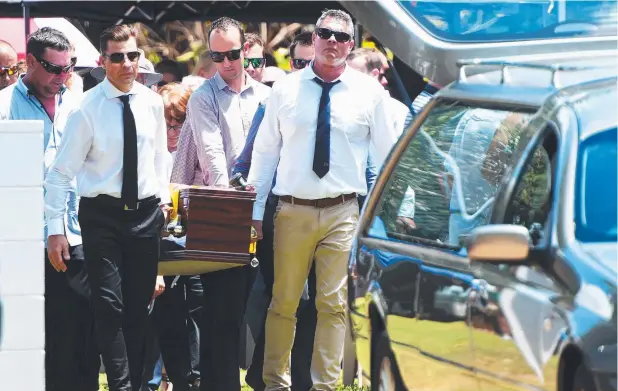  ??  ?? FINAL JOURNEY: Corey Christense­n’s coffin is carried to the hearse at yesterday’s funeral service at Alva Beach. Picture: ZAK SIMMONDS