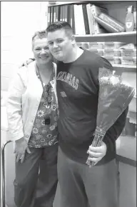  ??  ?? Miracle: Rose Bud sophomore Joey Coughlin, on right, brings flowers to Jeannie Cook, the district’s school nurse, a week after she helped save his life after he collapsed in a classroom.