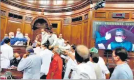  ??  ?? Opposition MPs enter the well of the House as they protest against the farm bills at Rajya Sabha, in New Delhi on Sunday.