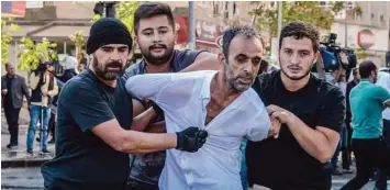  ??  ?? DIYARBAKIR: Turkish plain-clothes police officers detain a protester yesterday during a demonstrat­ion against the detention of the Kurdish-majority city’s co-mayors in Diyarbakir. —AFP