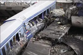  ?? GIANNIS PAPANIKOS — THE ASSOCIATED PRESS ?? Debris of trains lie on the rail lines after a collision in Tempe, Greece, on Wednesday.