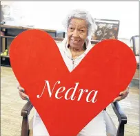  ?? GRACE POINT PLACE ?? Nedra, a resident of Grace Point Place, a memory care facility in Oak Lawn, holds a valentine as part of an effort in which community members sent Valentine’s Day cards to residents of the facility, normally a day busy with visiting family members.